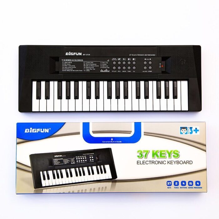 stage for kids A 37 Keys Kids Electric Piano with a black box next to it.