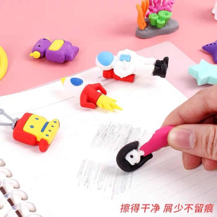stage for kids A person is writing on a 3D Cute Theme Children Eraser Stationery Set.